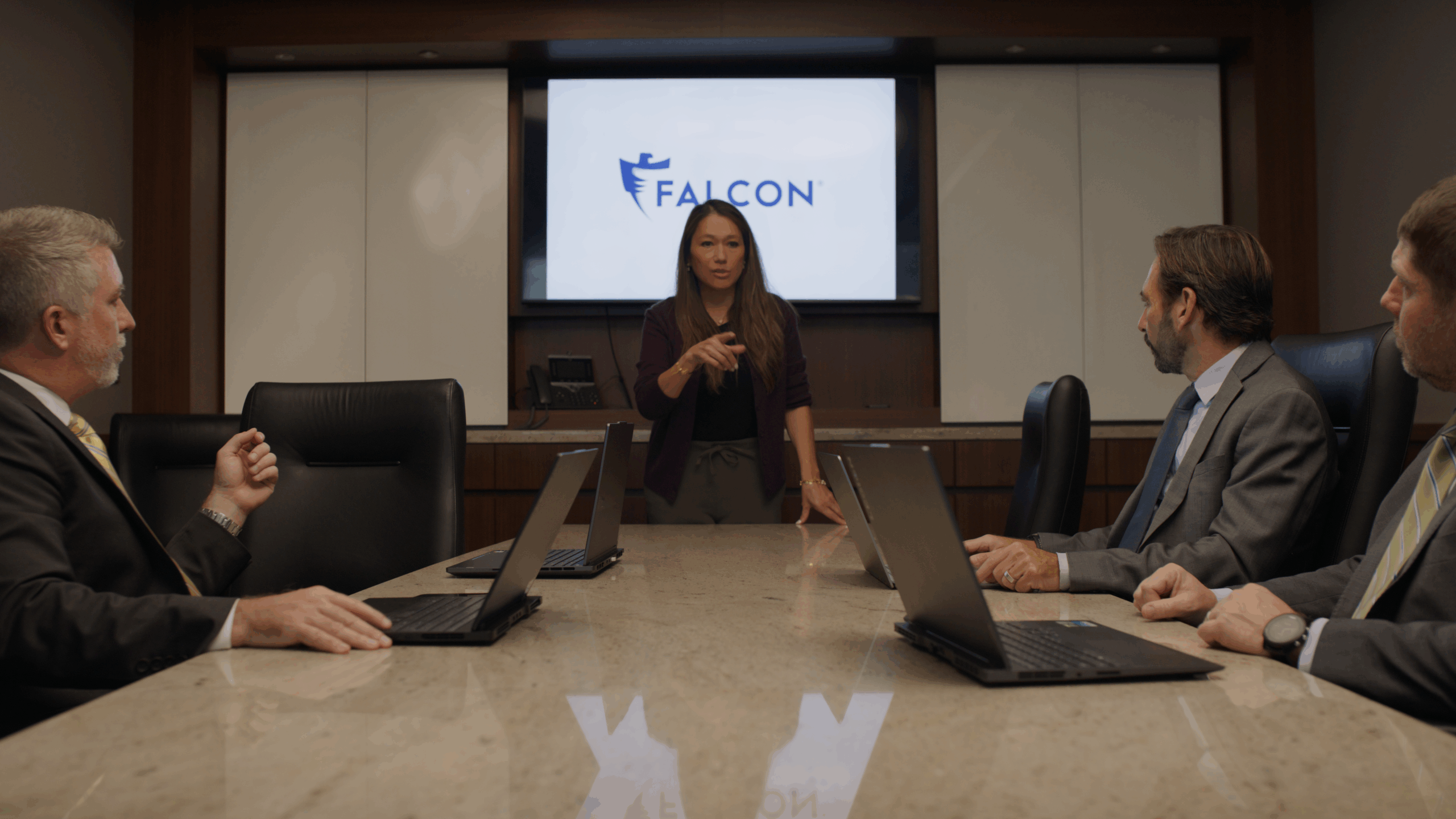 Dr. Elizabeth Falcon speaking to employees in a conference room