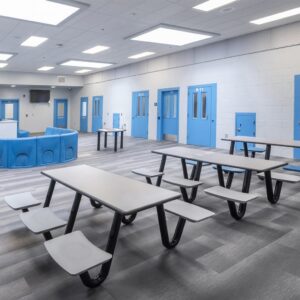tables and chairs in a prison dayroom