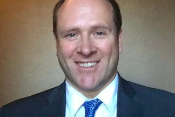 headshot photo of Jon Murad wearing suit and tie
