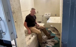 a man inside small, cramped cell at Hutchinson Correction Facility in Kansas