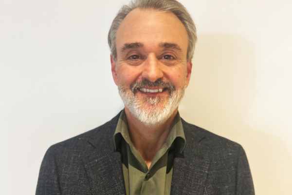 headshot photo of Guy Mallozzi wearing collared shirt and jacket