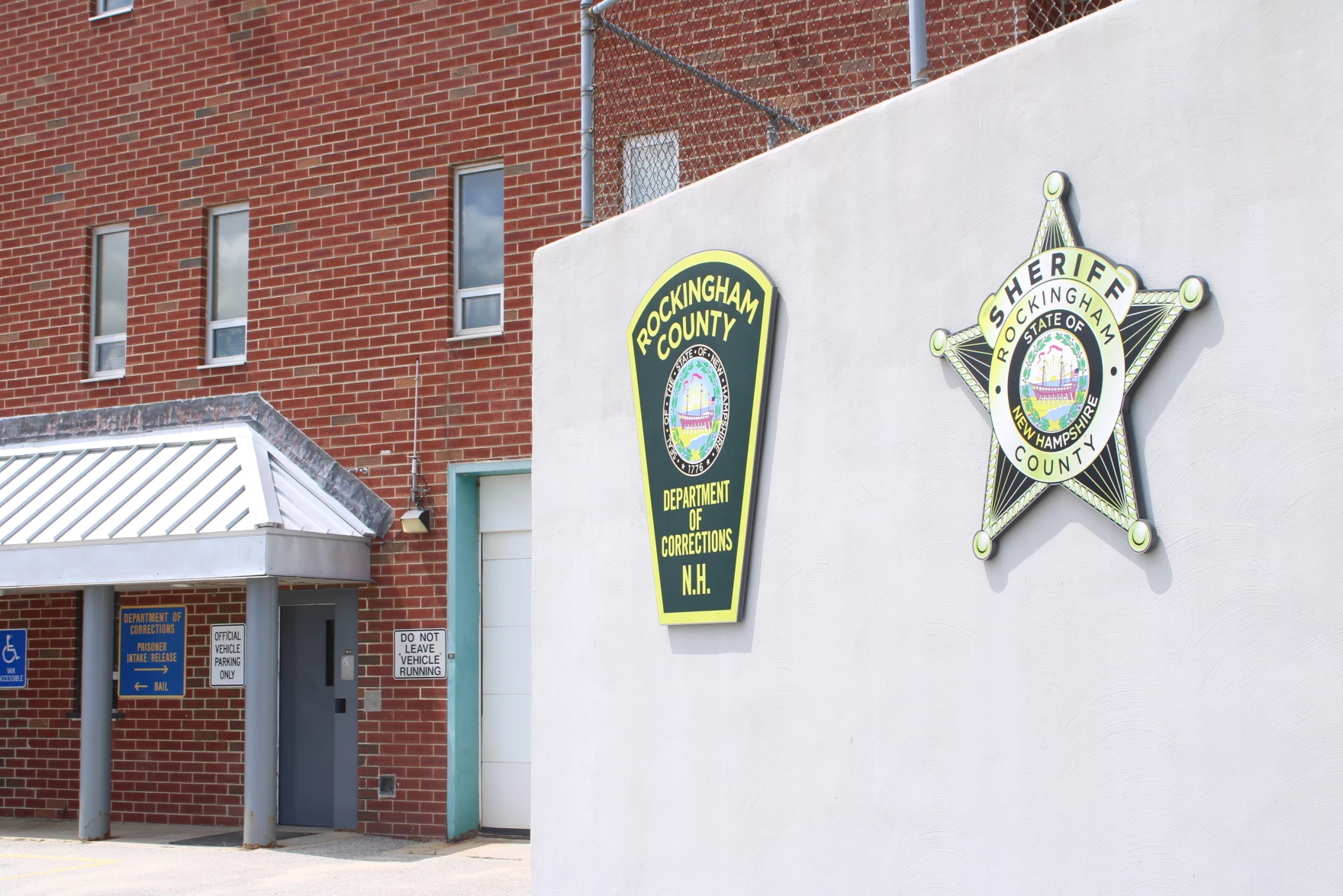 front of Rockingham County Corrections Department facility with department logo on wall