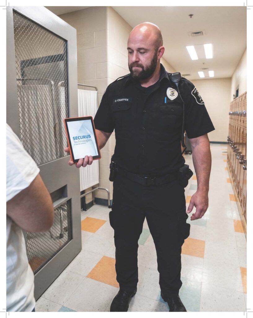 corrections officer holding Securus tablet