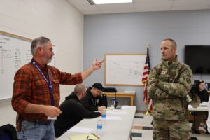 Montana DOC staffer speaks with National Guard member
