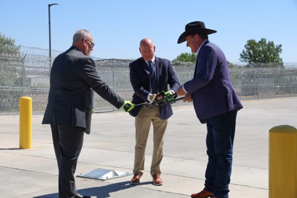 South Dakota Department of Corrections Secretary Nick Lamb, Warden Eric Aldridge and Governor Larry Rhoden cut a piece of wire at the Rapid City Women's Prison