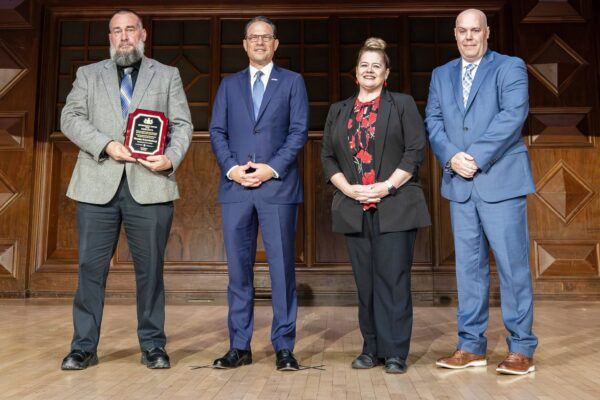 Tim Schweinsburg, Gov. Josh Shapiro, Dr. Laurel Harry and Reed Davy at an awards ceremony