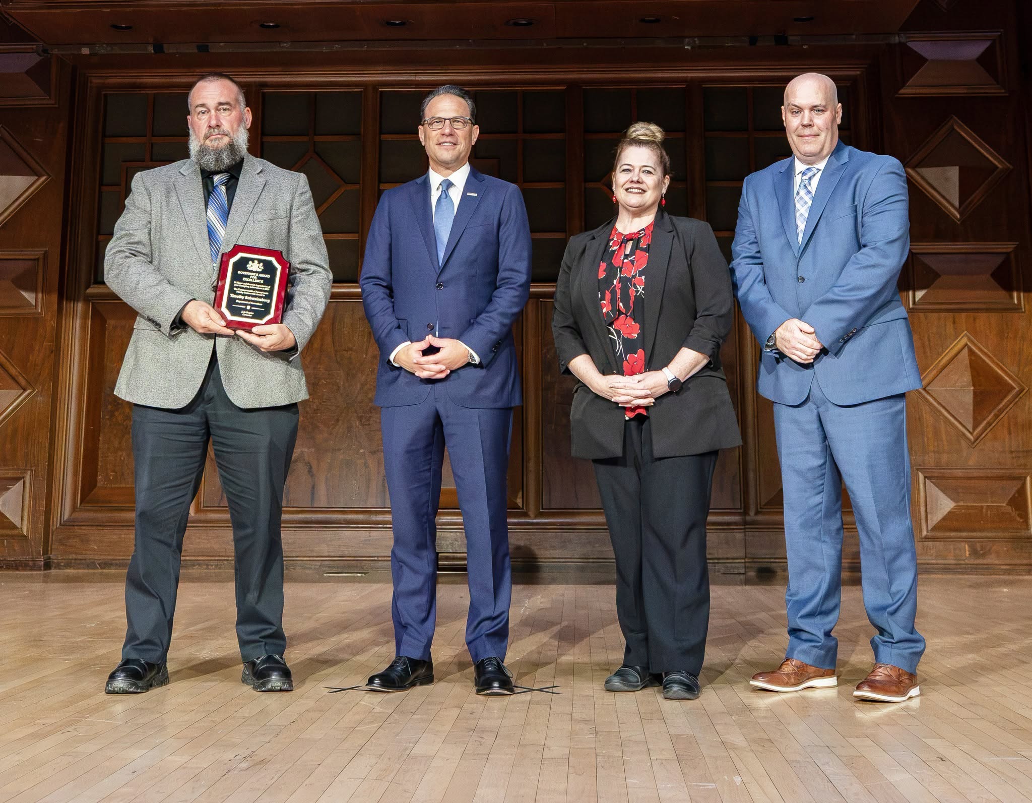 Tim Schweinsburg, Gov. Josh Shapiro, Dr. Laurel Harry and Reed Davy at an awards ceremony