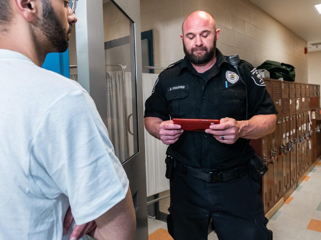 correctional officer using tablet