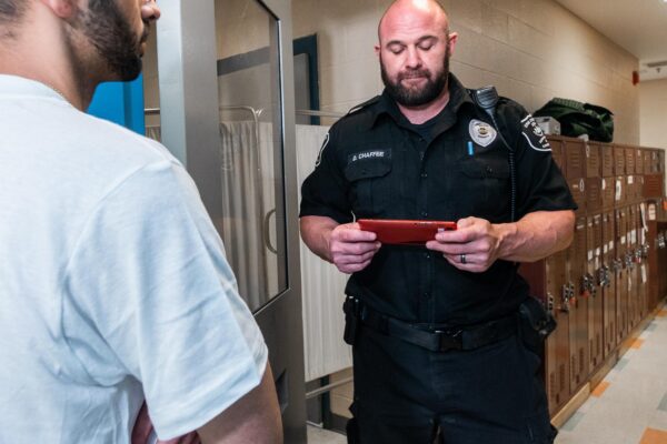 correctional officer using tablet