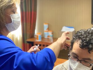 healthcare professionals training patient on acupuncture